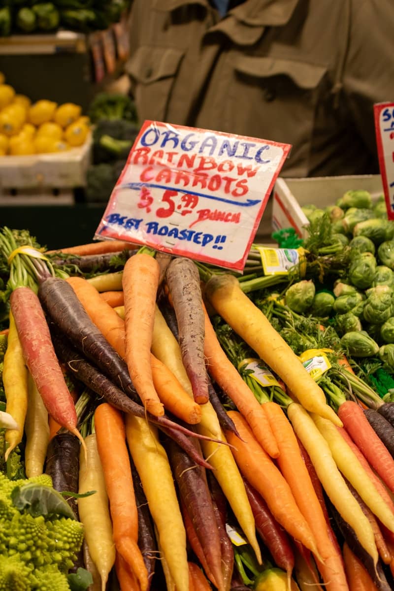 Organic rainbow carrots displayed at a market.