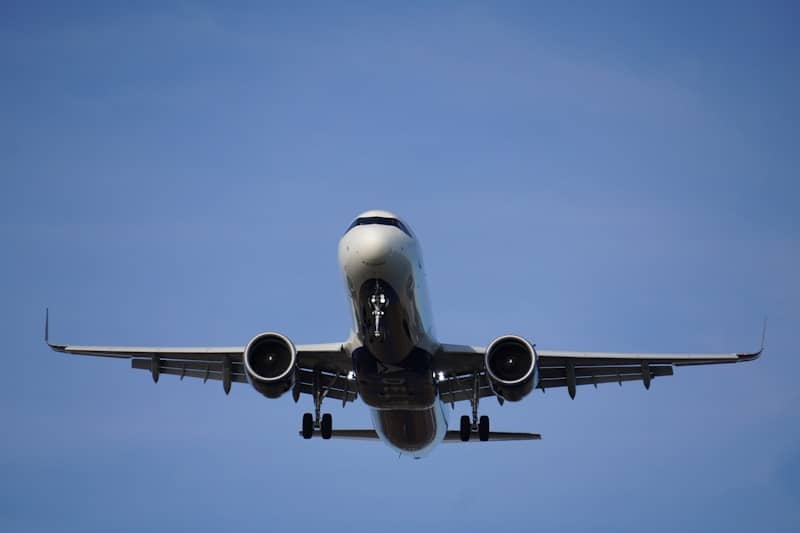 A large jetliner flying through a blue sky