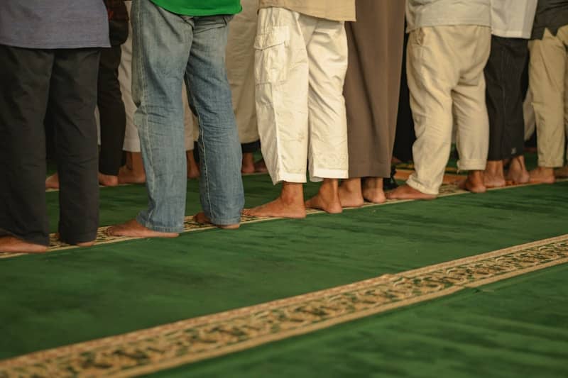 A group of people standing in a line on a rug