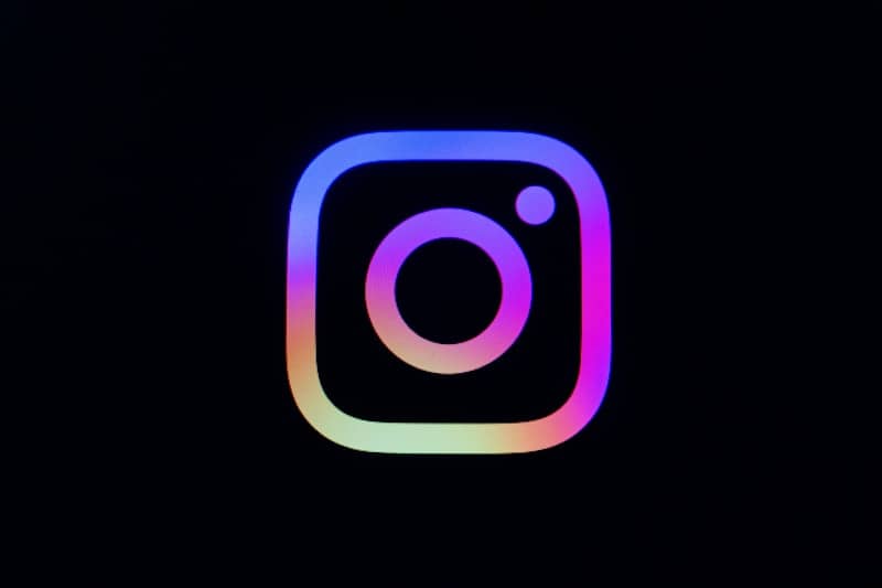 Instagram logo with colorful gradient on black