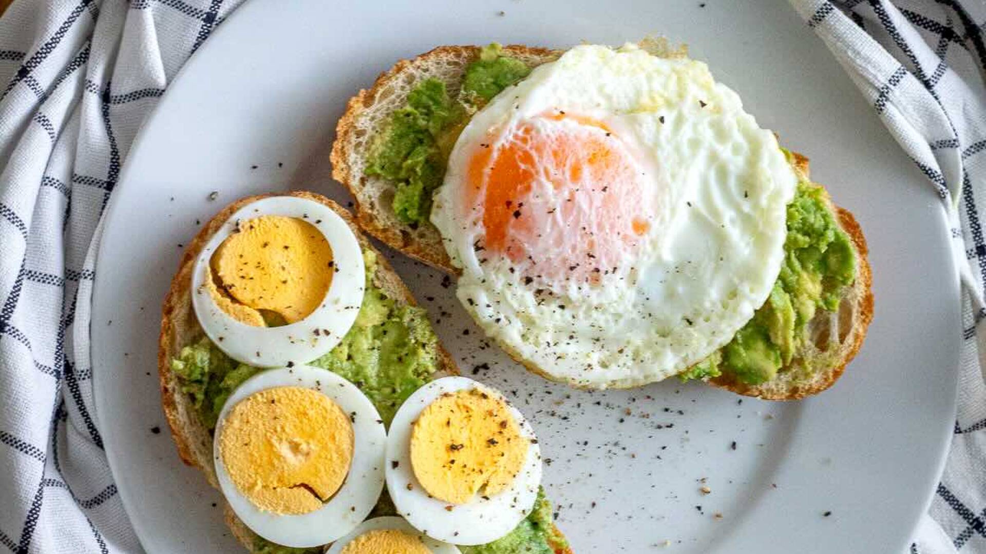 Avocado Eggs Toast served with boiled egg and a fried egg.