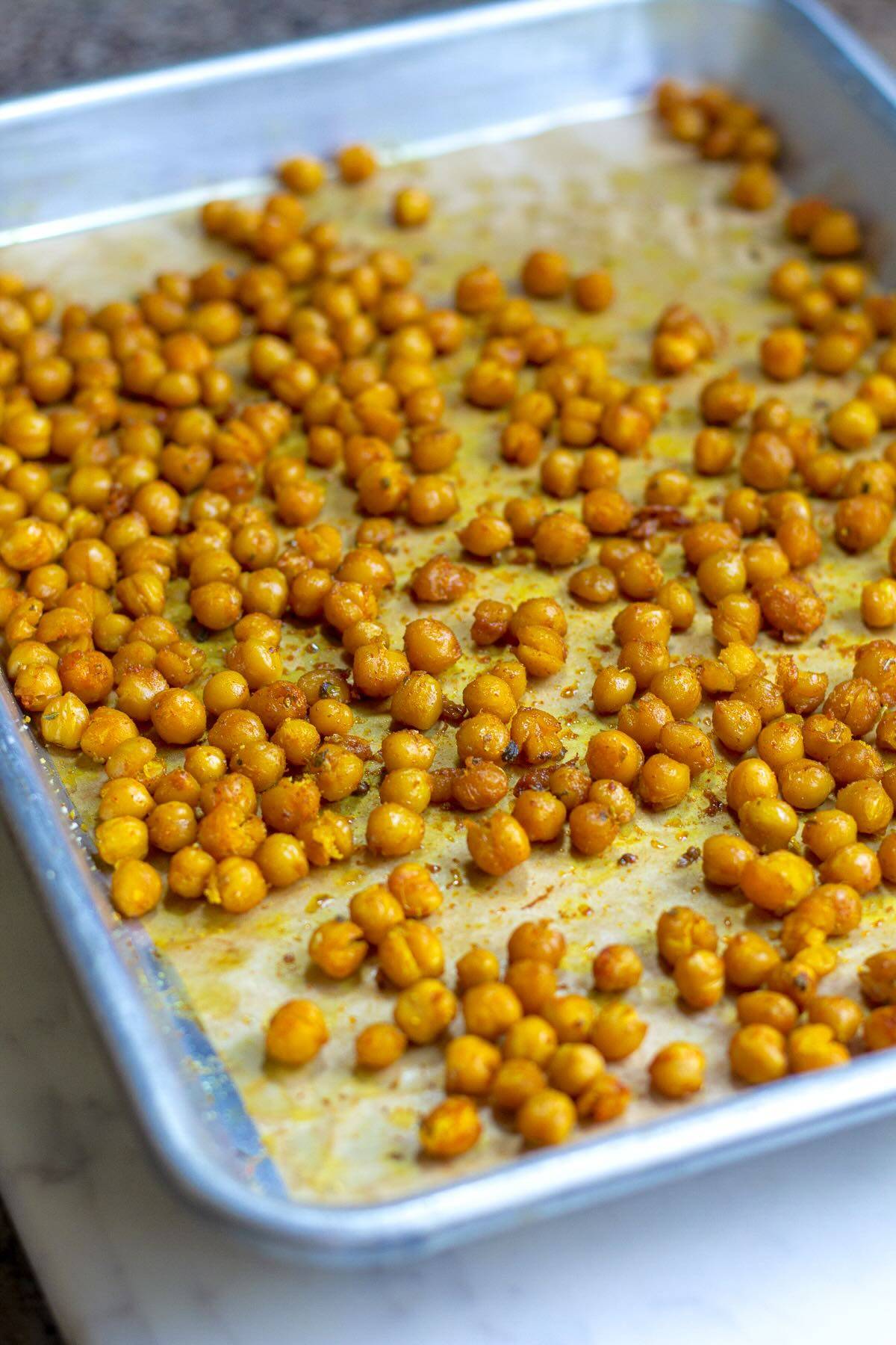 Oven roasted turmeric chickpeas shown on a baking pan
