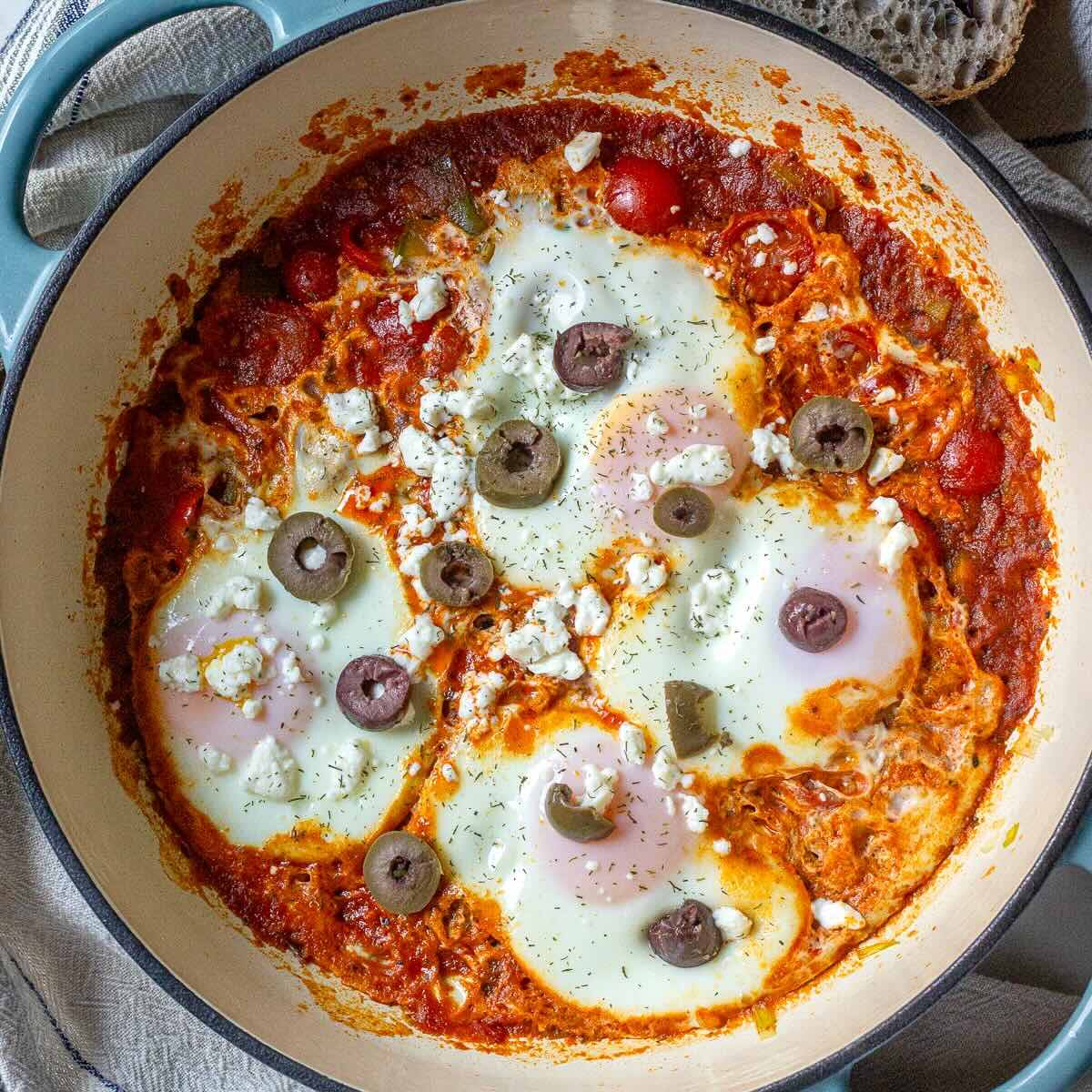 Healthy one-pan shakshuka with leeks and eggs ready to serve for brunch.
