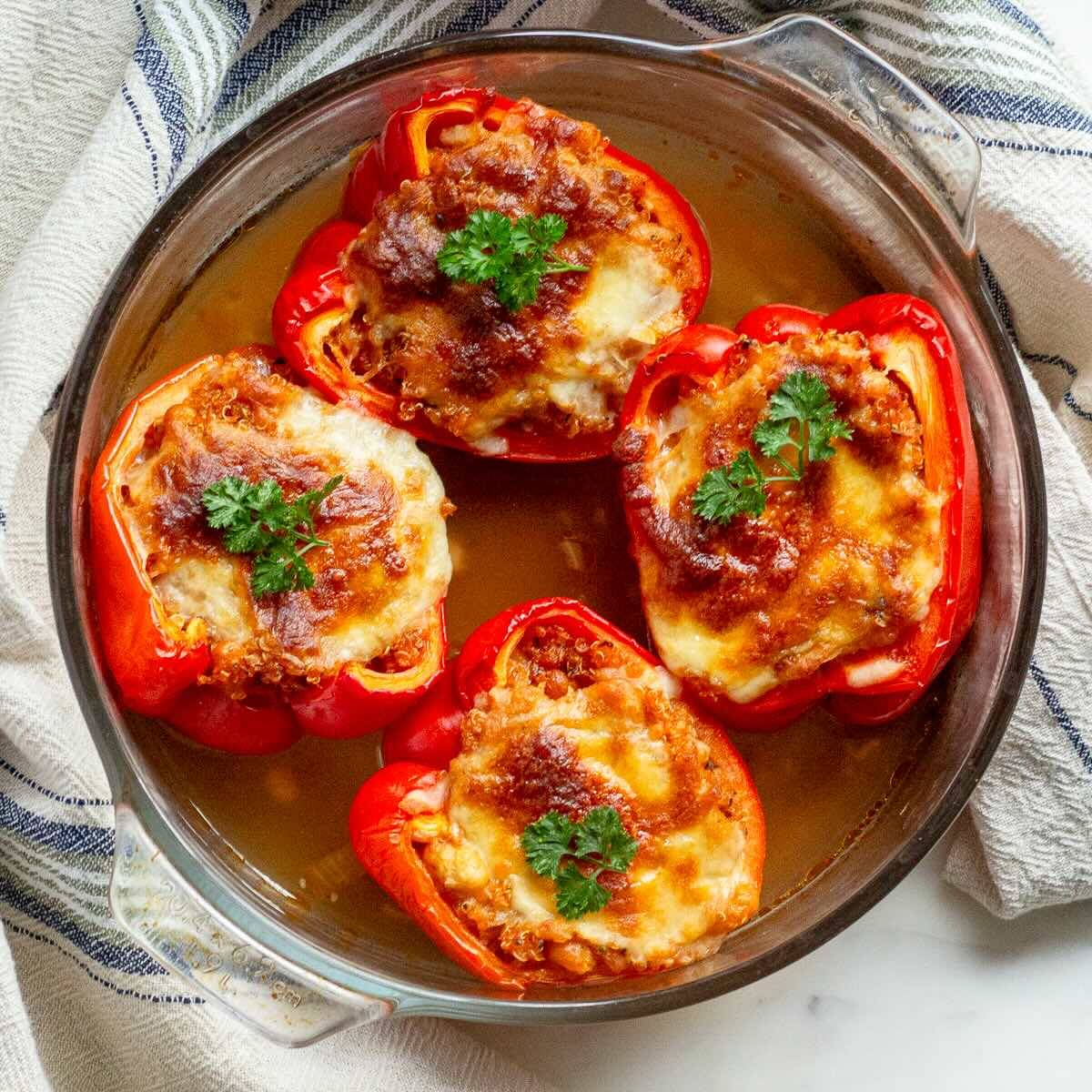 Vegetarian Stuffed Peppers shown with cheese and fresh parsley.
