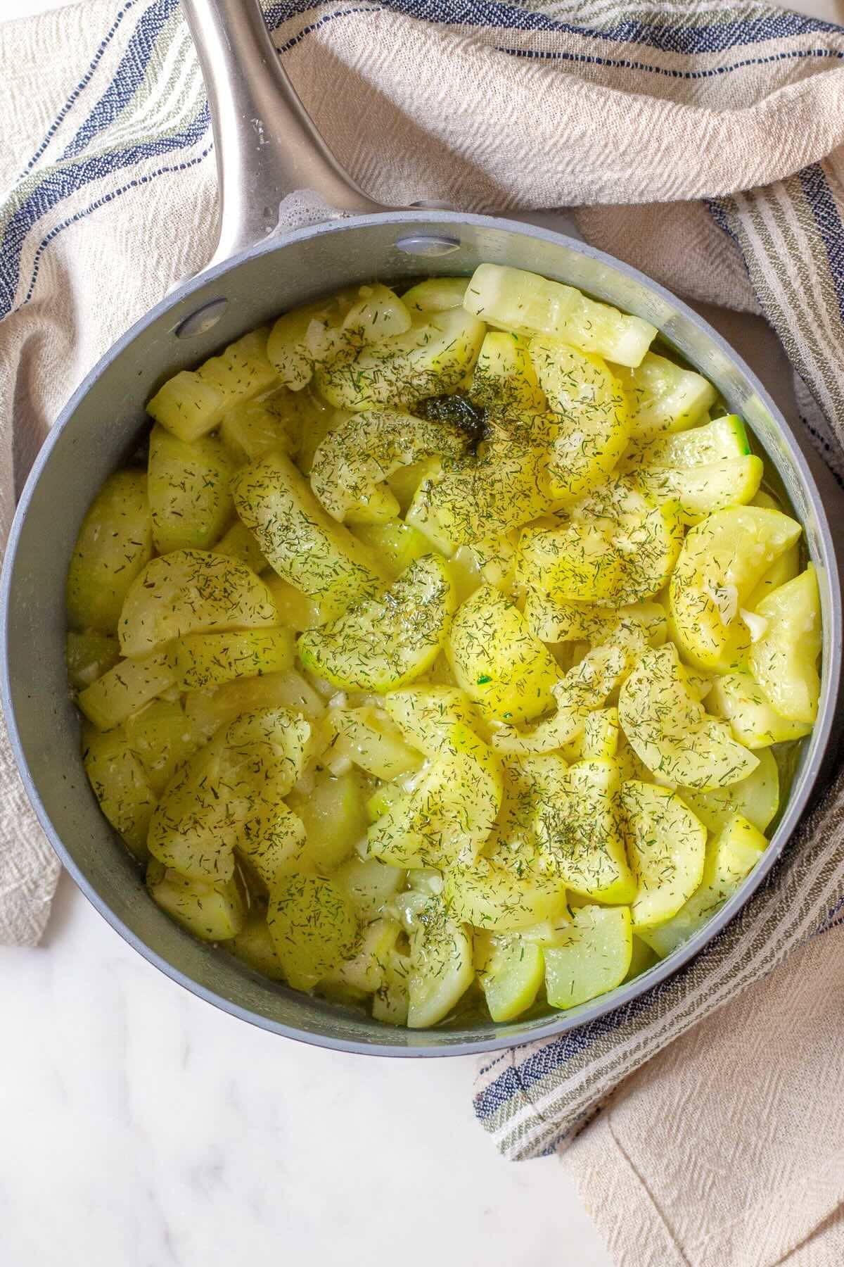 Stewed zucchini with garlic and dill in a pot