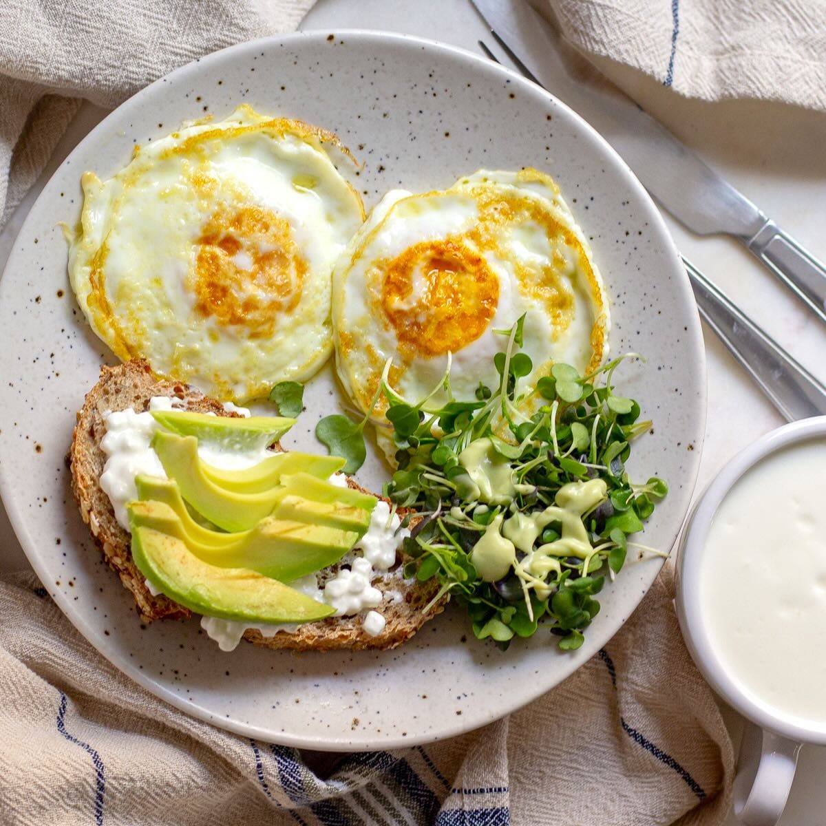 High-Protein Breakfast Eggs Served with Whole=Grain Bread, Cottage Cheese, Avocado, Microgreens and Kefir