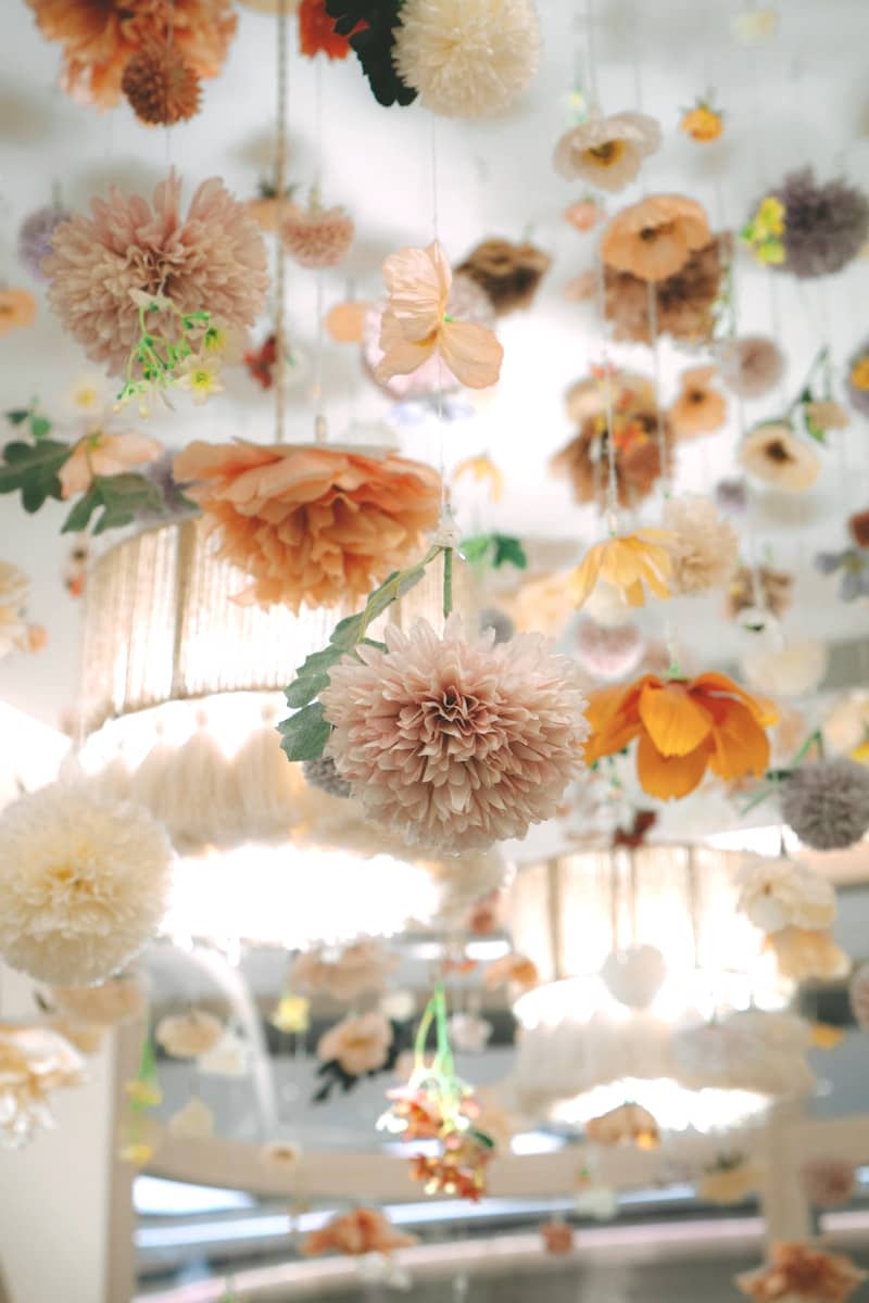Flowers and decorations hang from the ceiling.