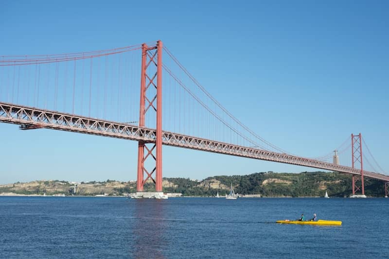 A red bridge spans over water.