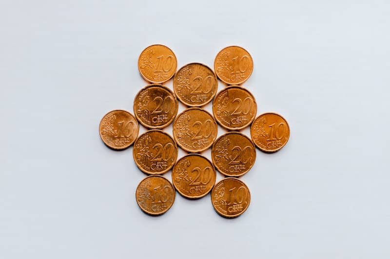 gold round coins on white surface