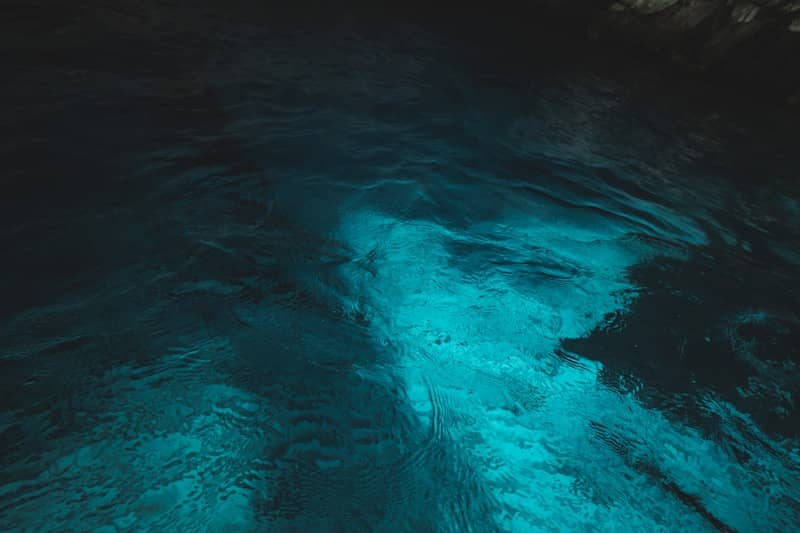 Glowing blue water in the dark.