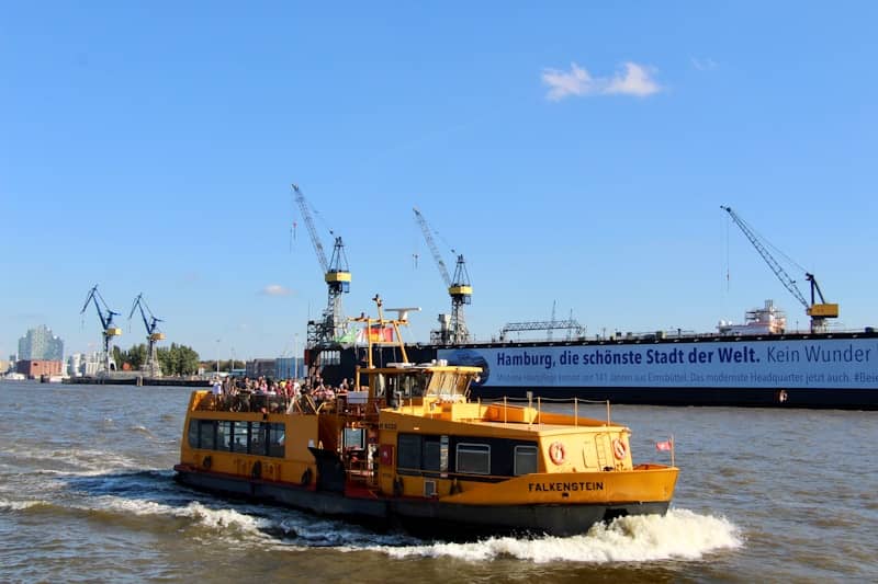 Yellow ferry boat with passengers on the water