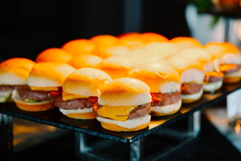 Rows of mini cheeseburgers on a platter