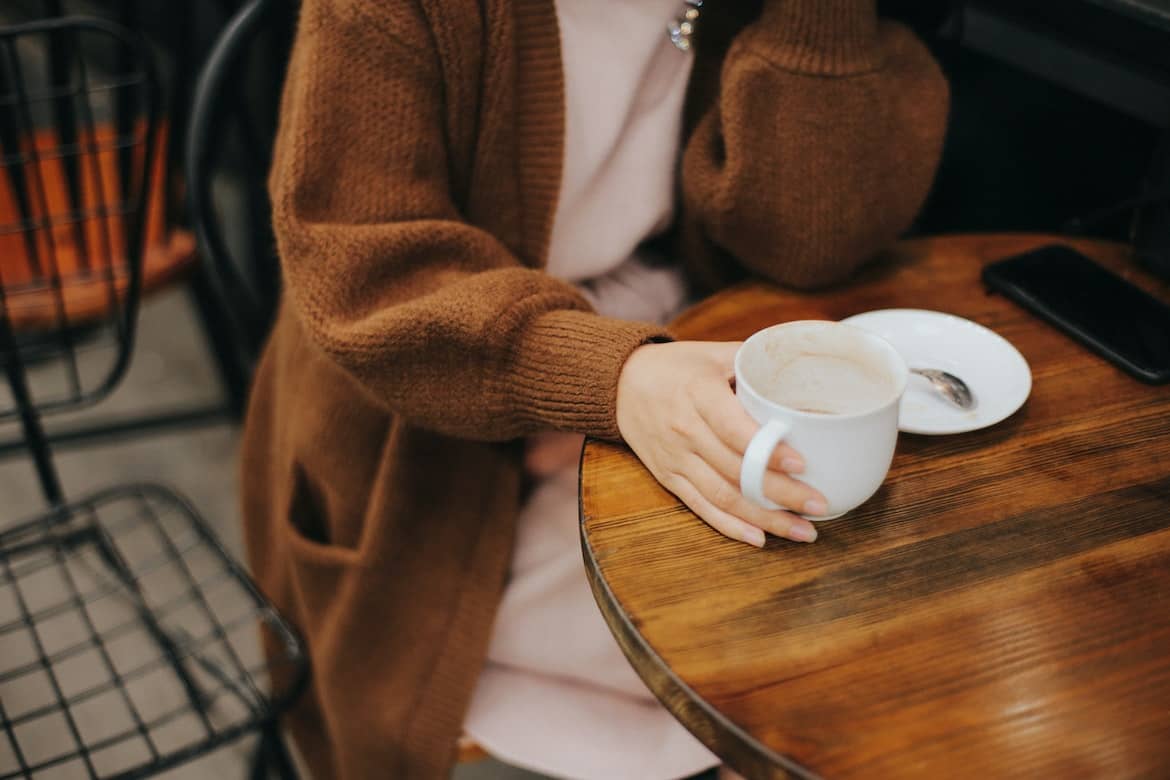 person holding mug