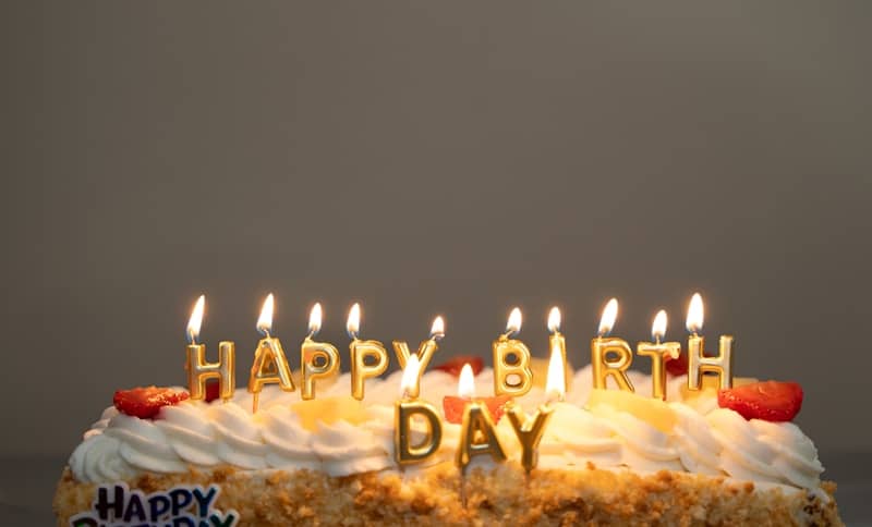 A birthday cake with candles that say happy birthday day