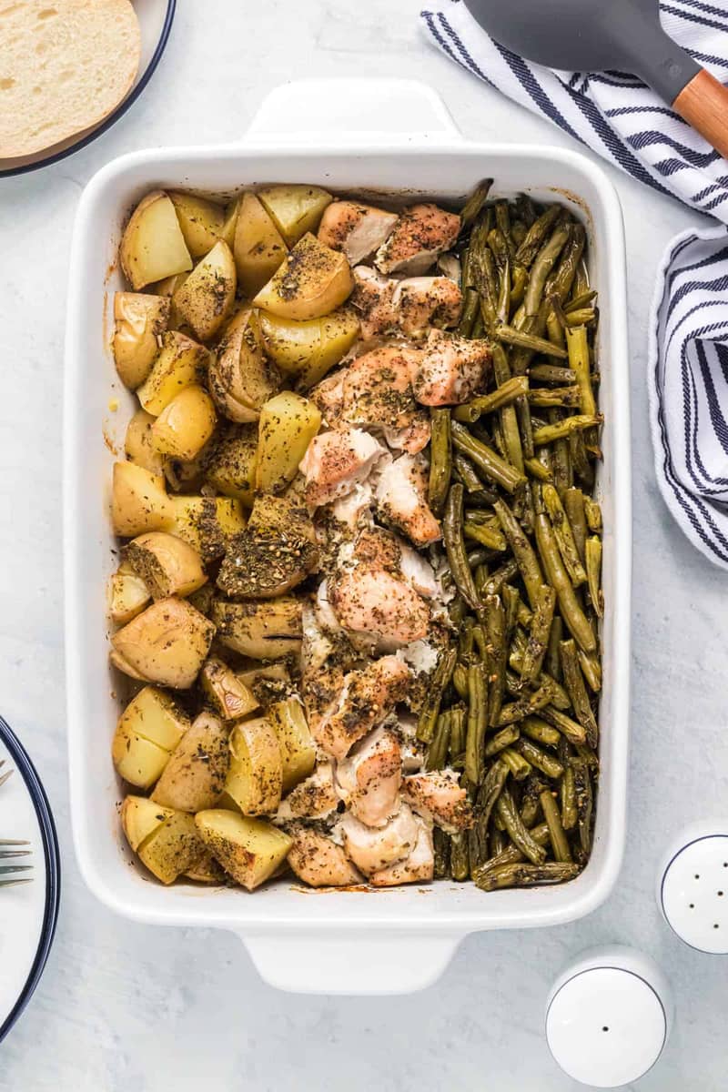 An image of one pan chicken with potatoes and green beans.