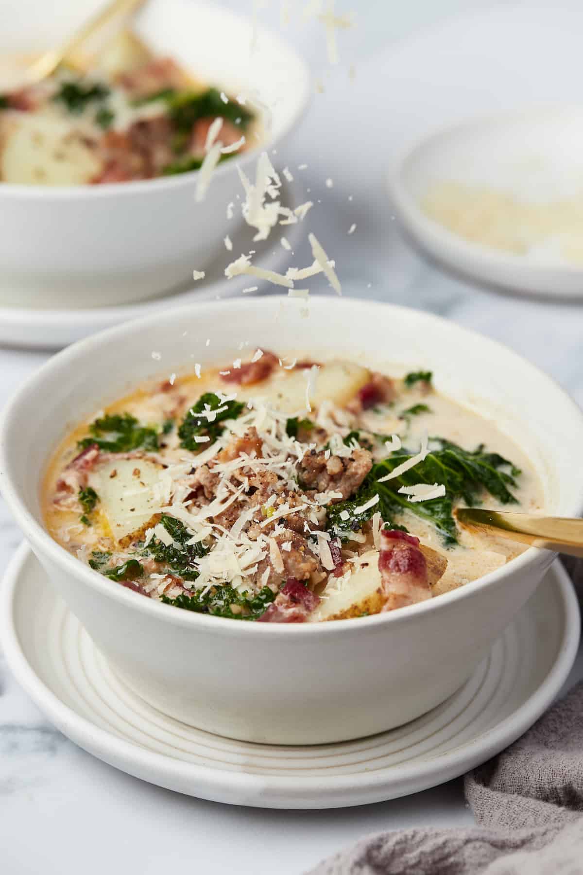 A bowl of Zuppa Toscana with parmesan.