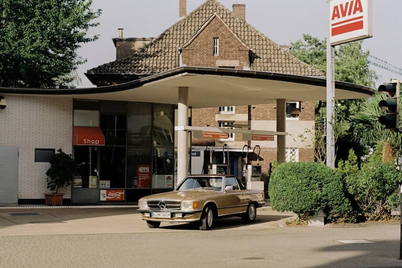 A gas station with a car parked in front of it