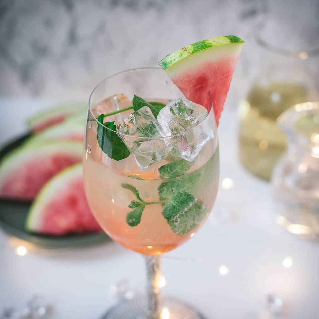 Light watermelon spritzer with bubbles, ice, and fresh watermelon, linking to the recipe.