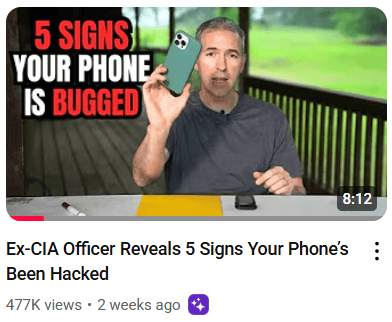 ex CIA agent holding a phone