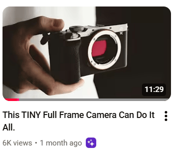man holding tiny camera