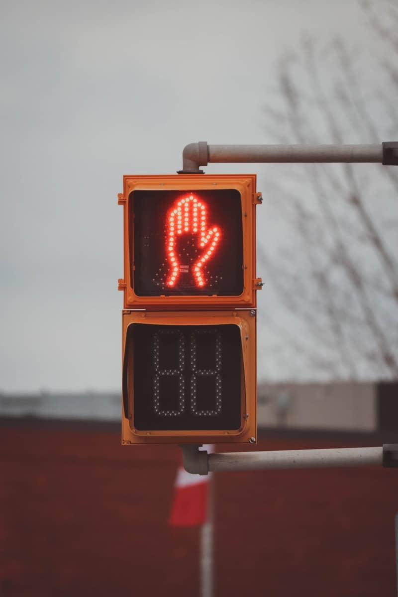 a traffic light that has a red hand on it