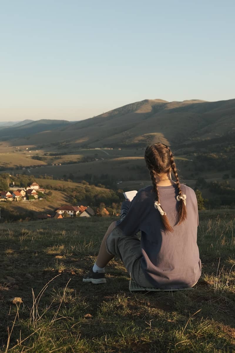 Girl sketching beautiful countryside landscape.