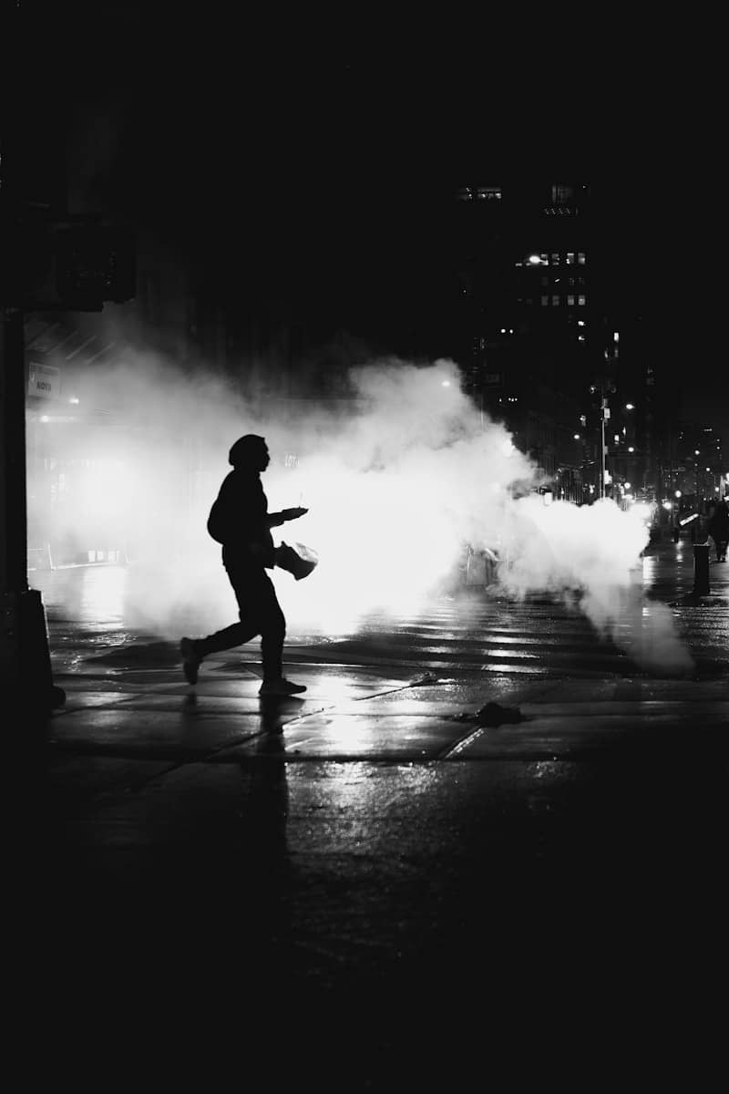A person running through smoke at night
