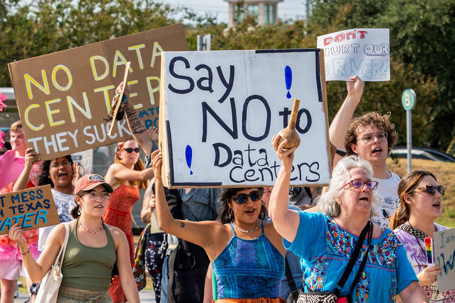 Protesters with anti-data center signs