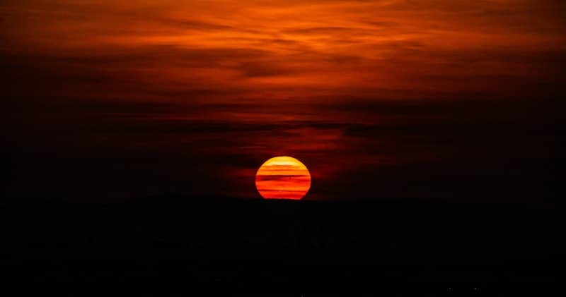Fiery sunset with dark clouds and horizon