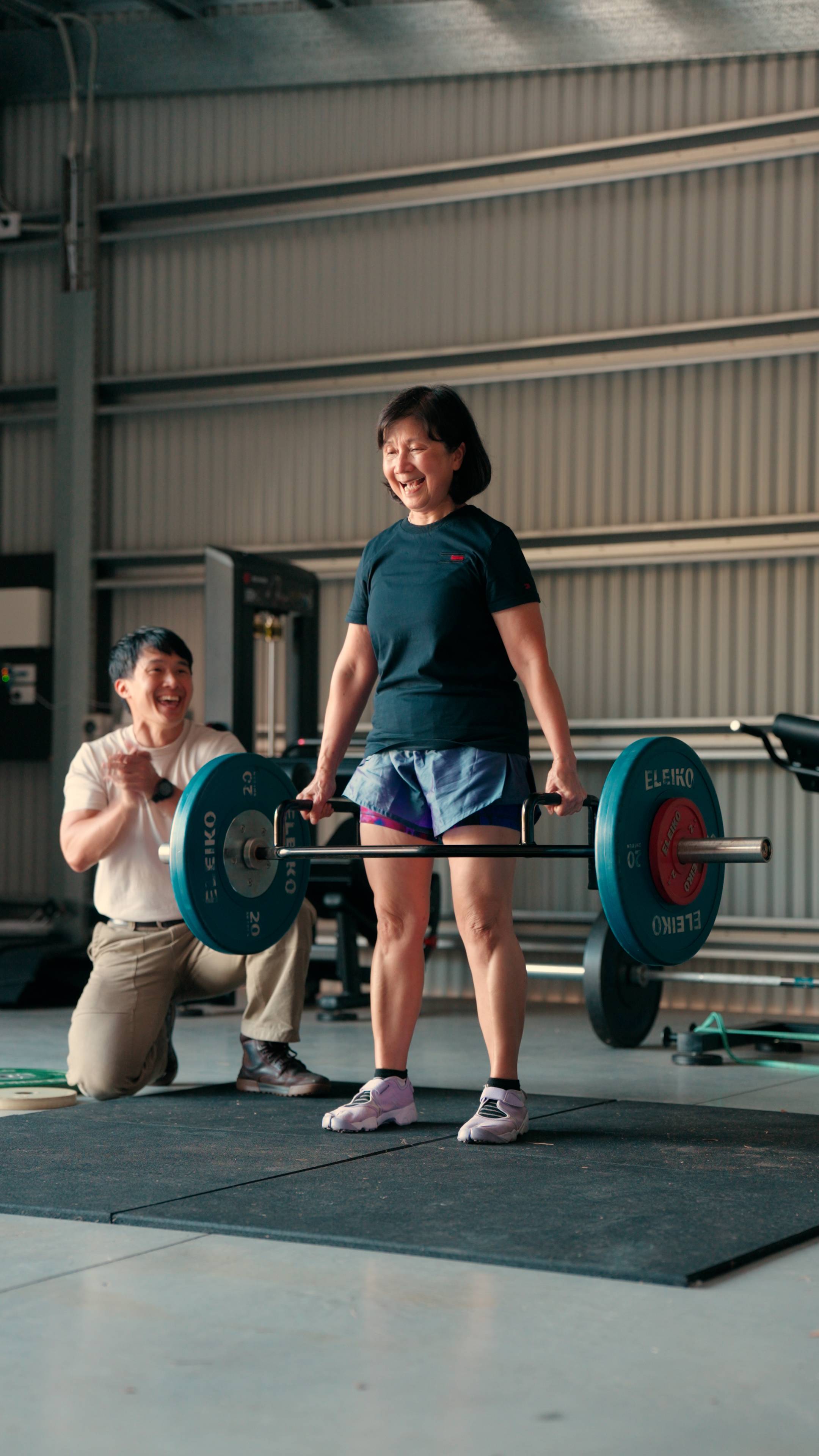 me and my mum lifting in the gym