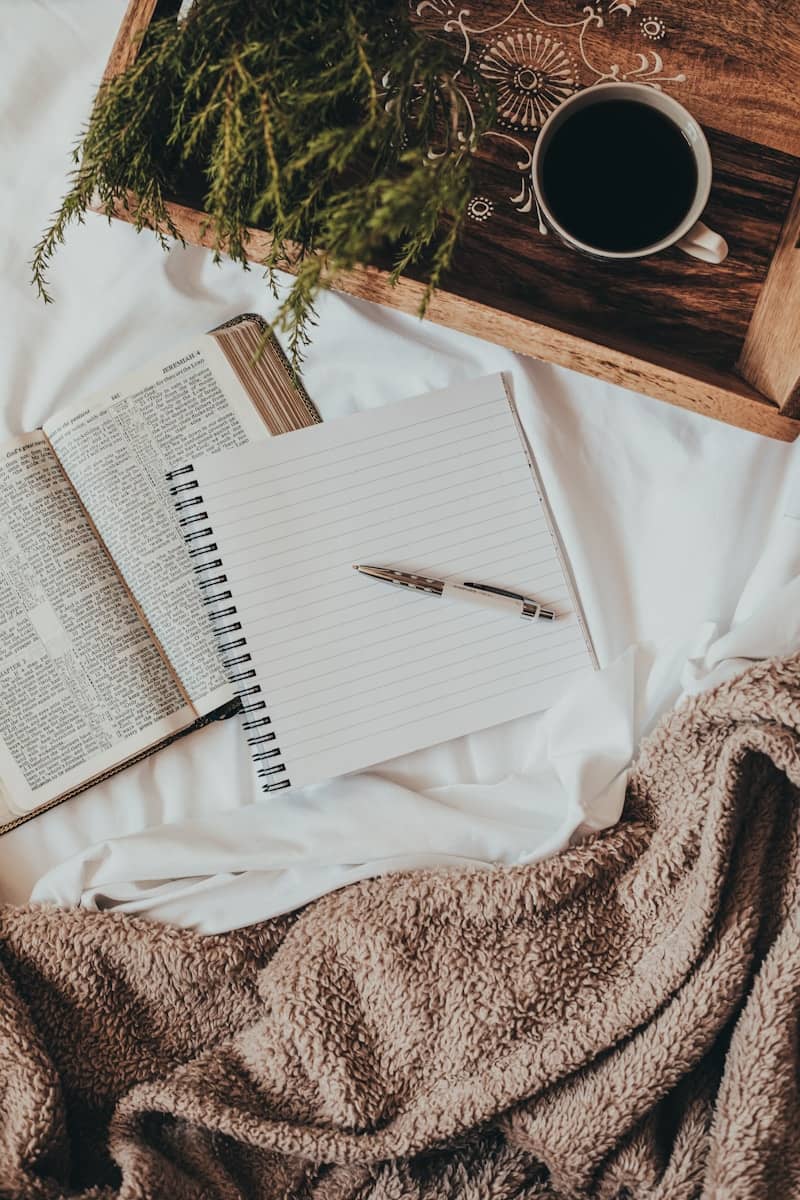 white notebook on white textile