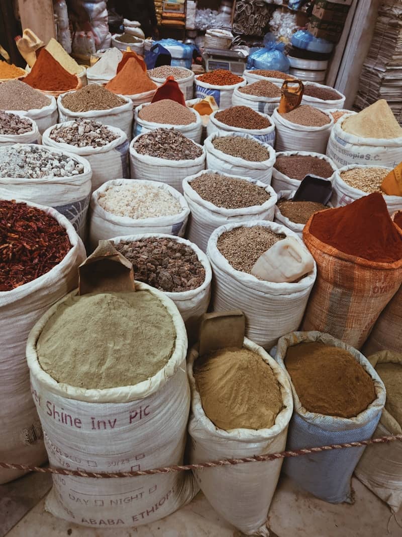 Sacks filled with colorful spices displayed in a vibrant market.