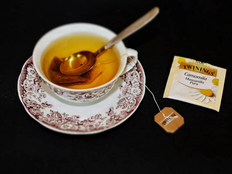 A cup of tea with a spoon on a saucer