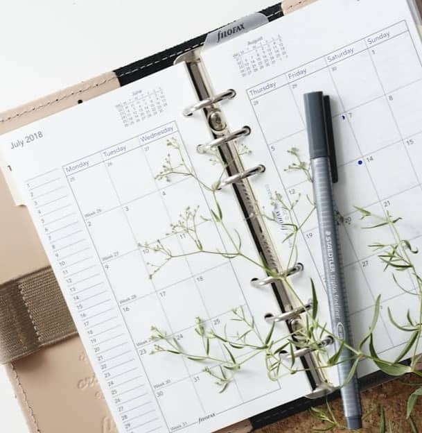 grey and black pen on calendar book