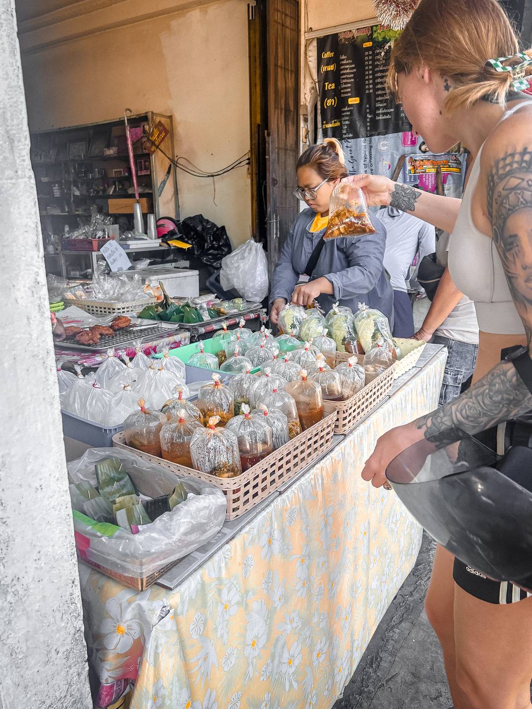 Women buying food bags at the local store in Thailand.