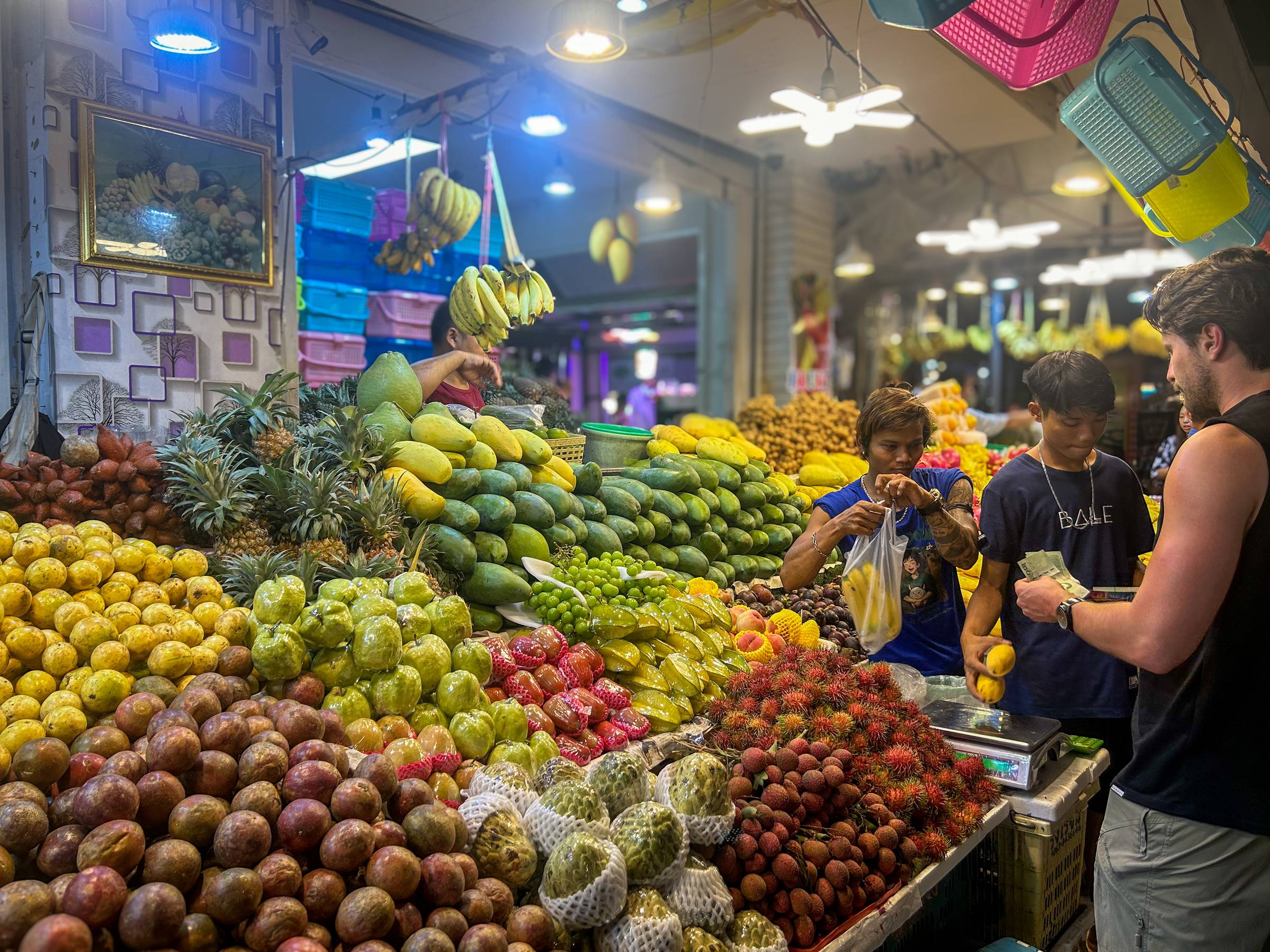 Man buying fruit at the night market in Phuket, Thailand