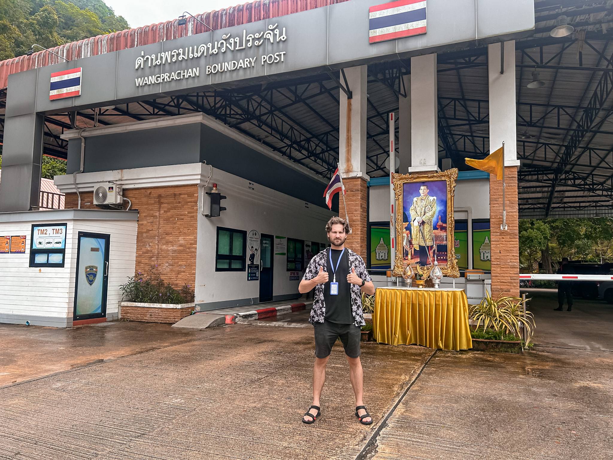 A man stood infront of the Thai/ Malaysian border