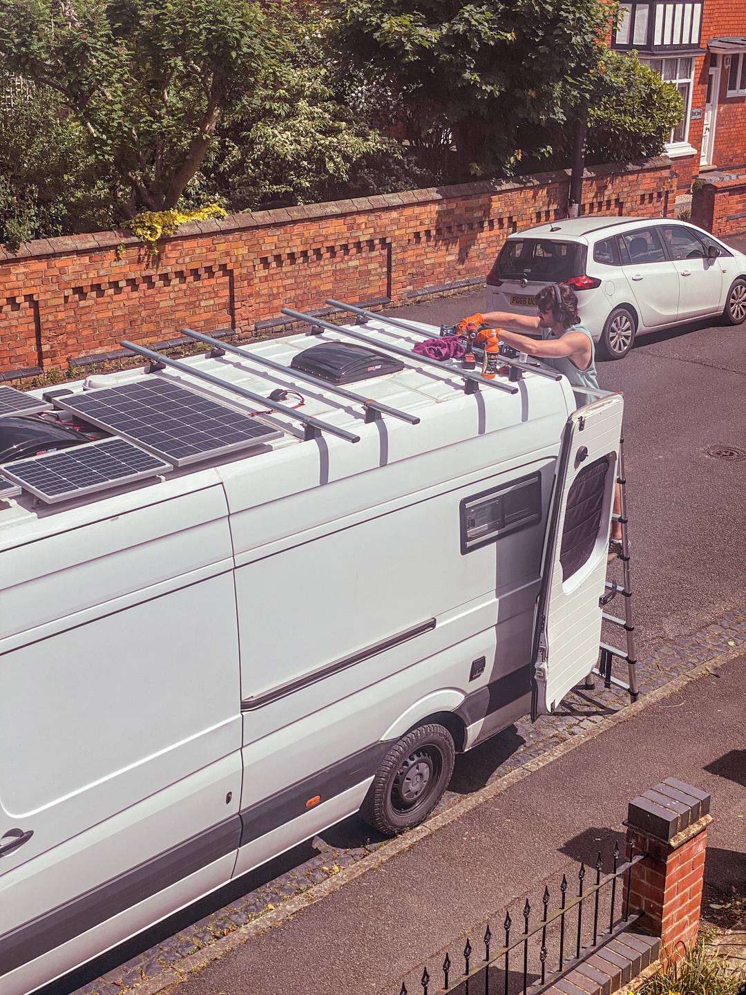 Sam treating our Mercedes Sprinter with rust converter and paint on the public road.