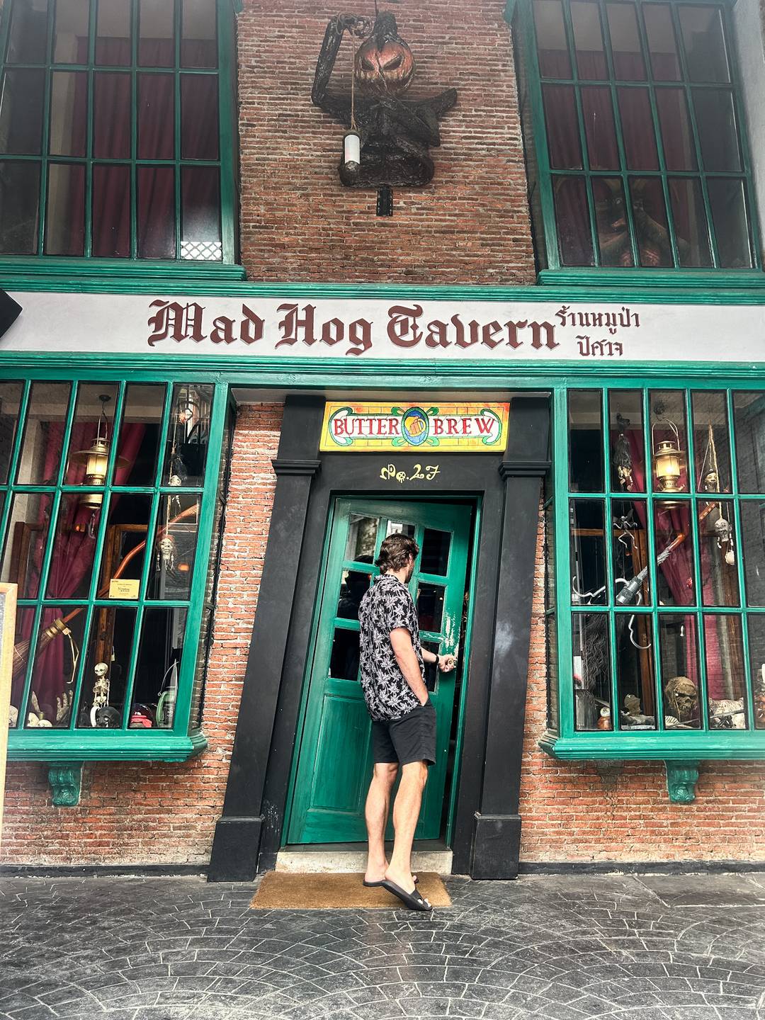 a man walking into the mad hog tavern in phucket 