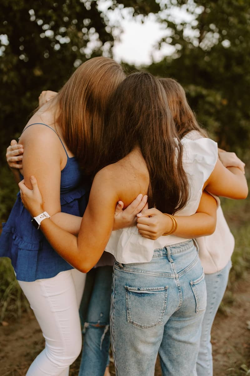 A group of young women hugging each other