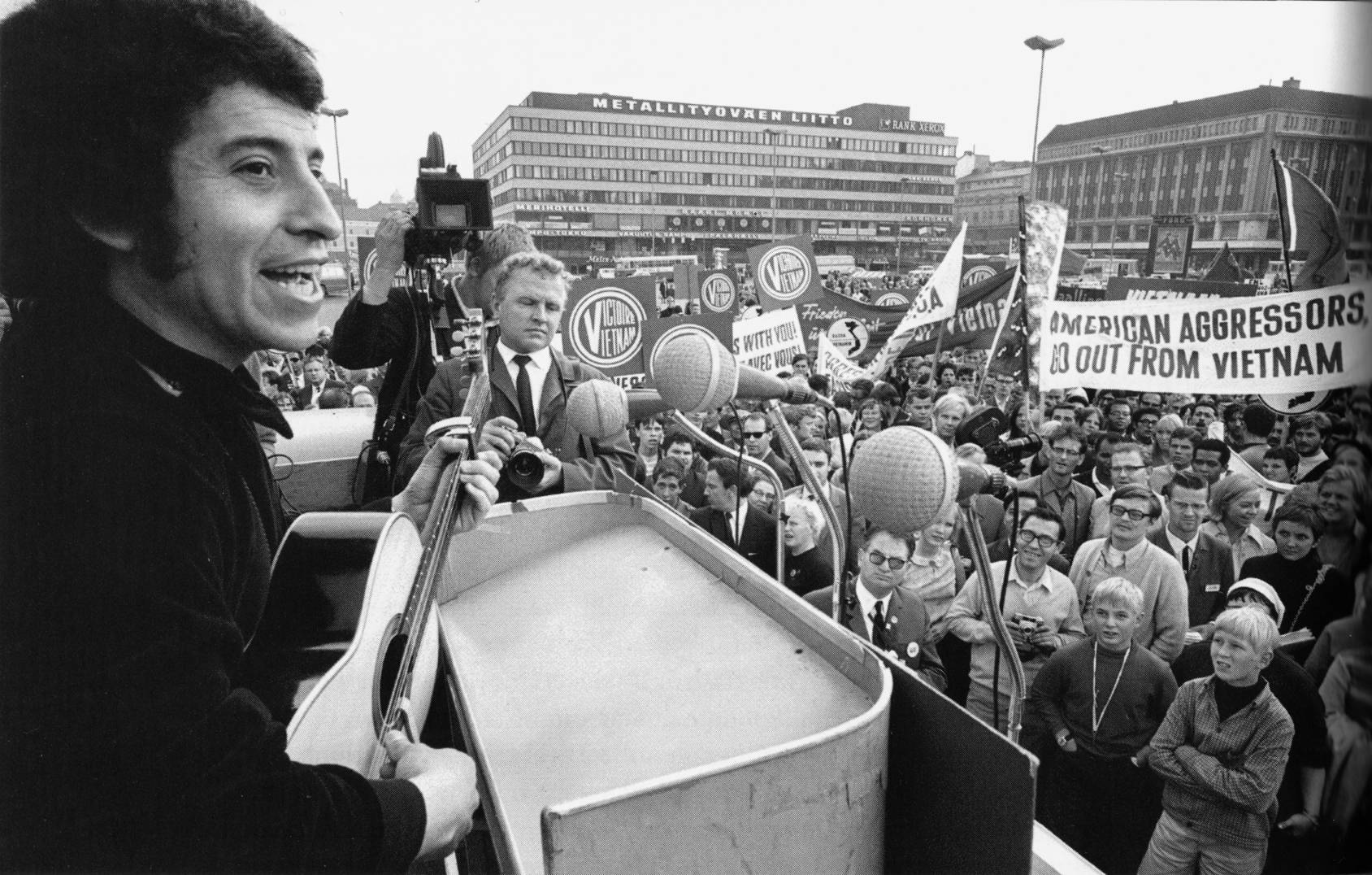 Víctor Jara durante una actuación pública en Helsinki en 1969, con una guitarra frente a una concentración.