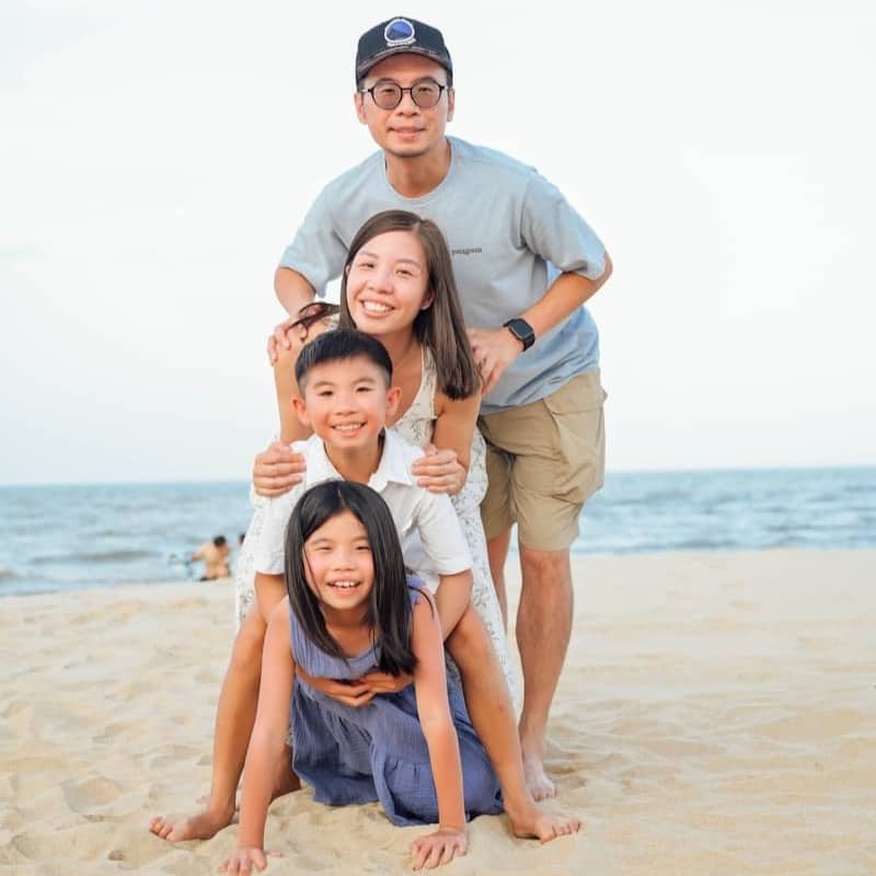 Family stacked on each other at the beach