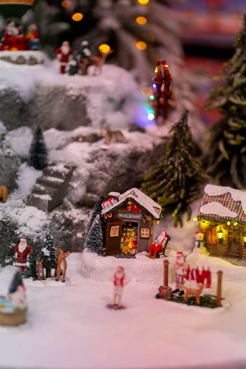 Miniature christmas village scene with santa figures