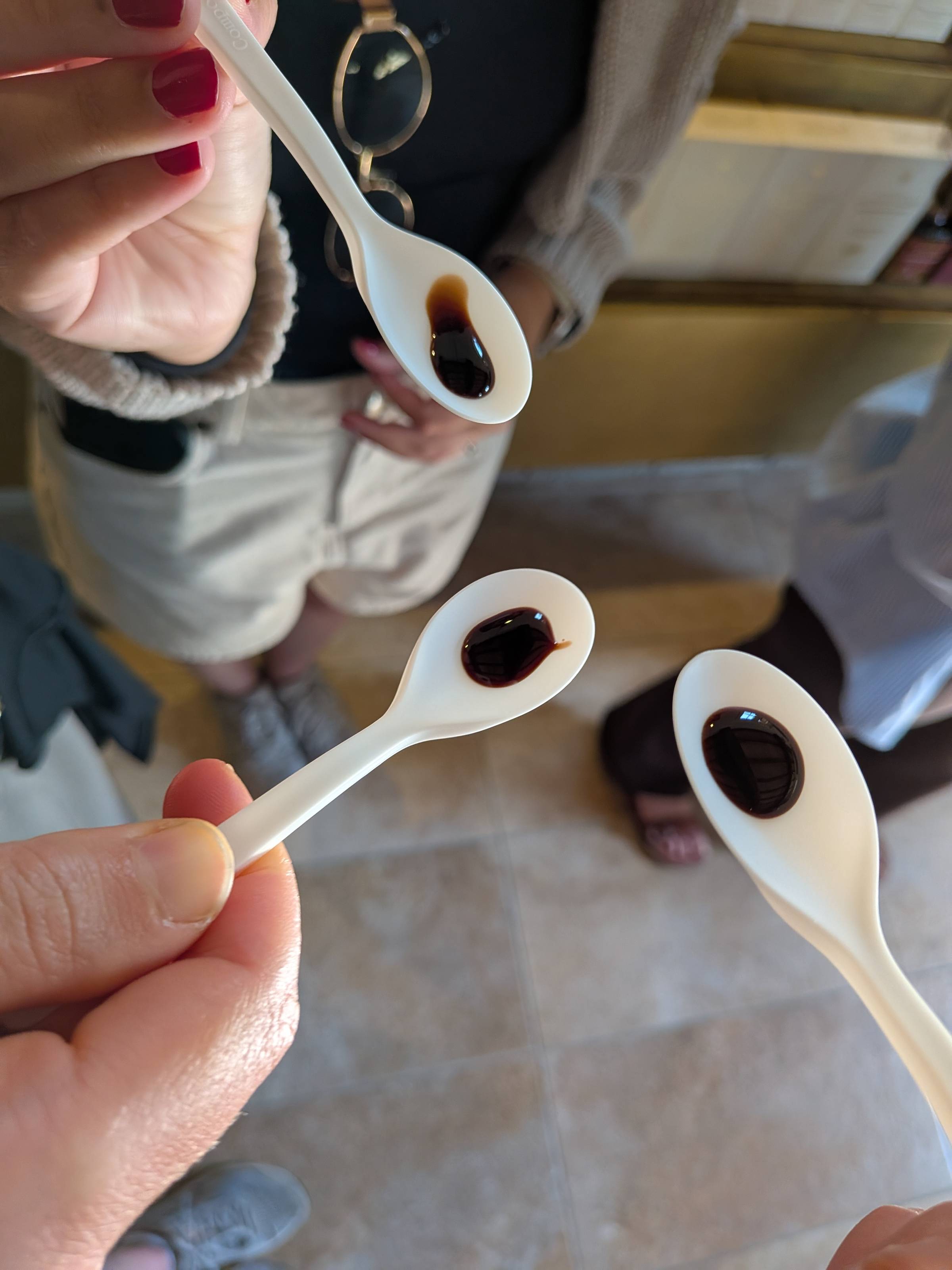 three spoons holding balsamic vinegar