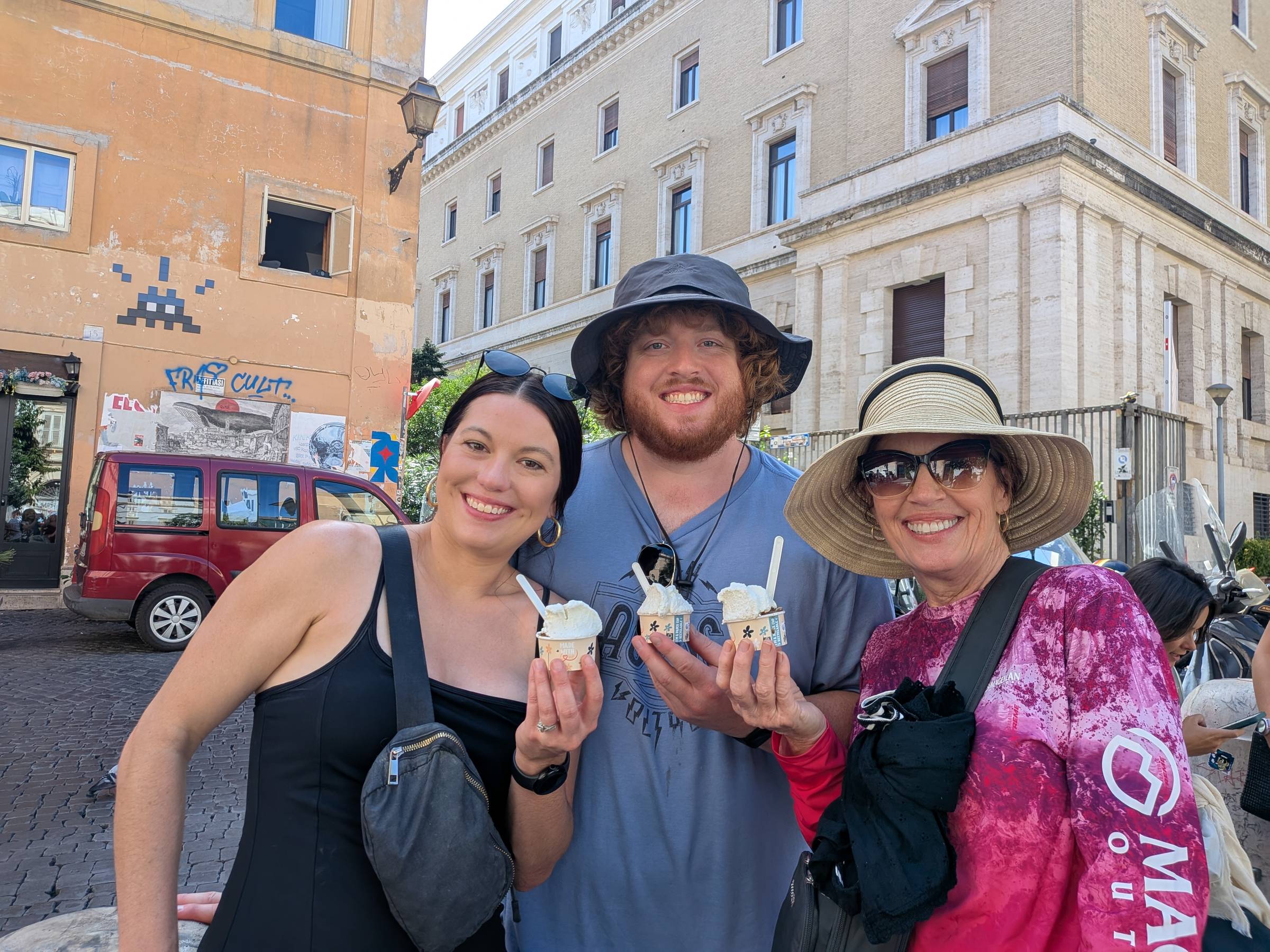 three people holding cups of granita.