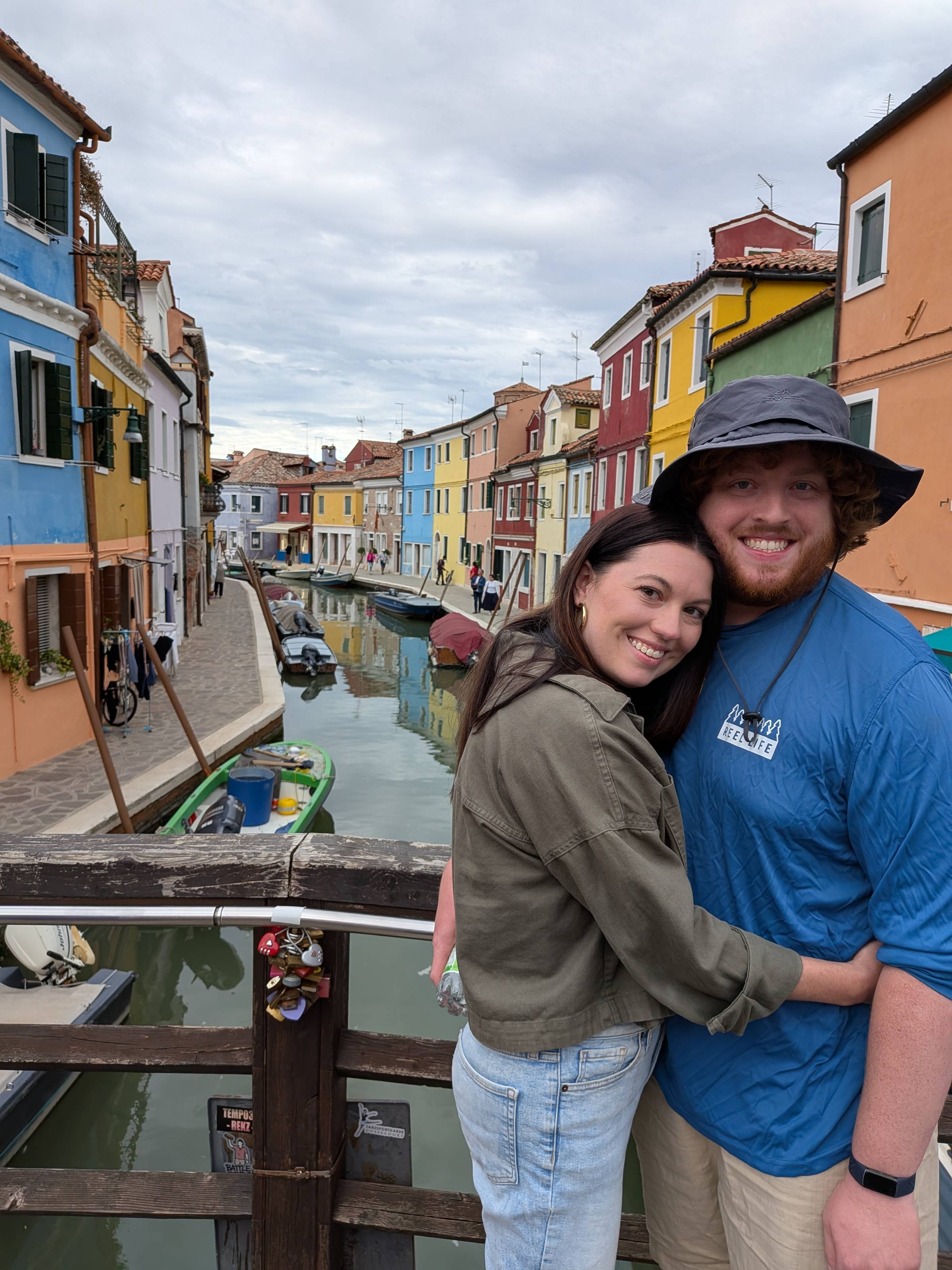 two people in front of colorful houses