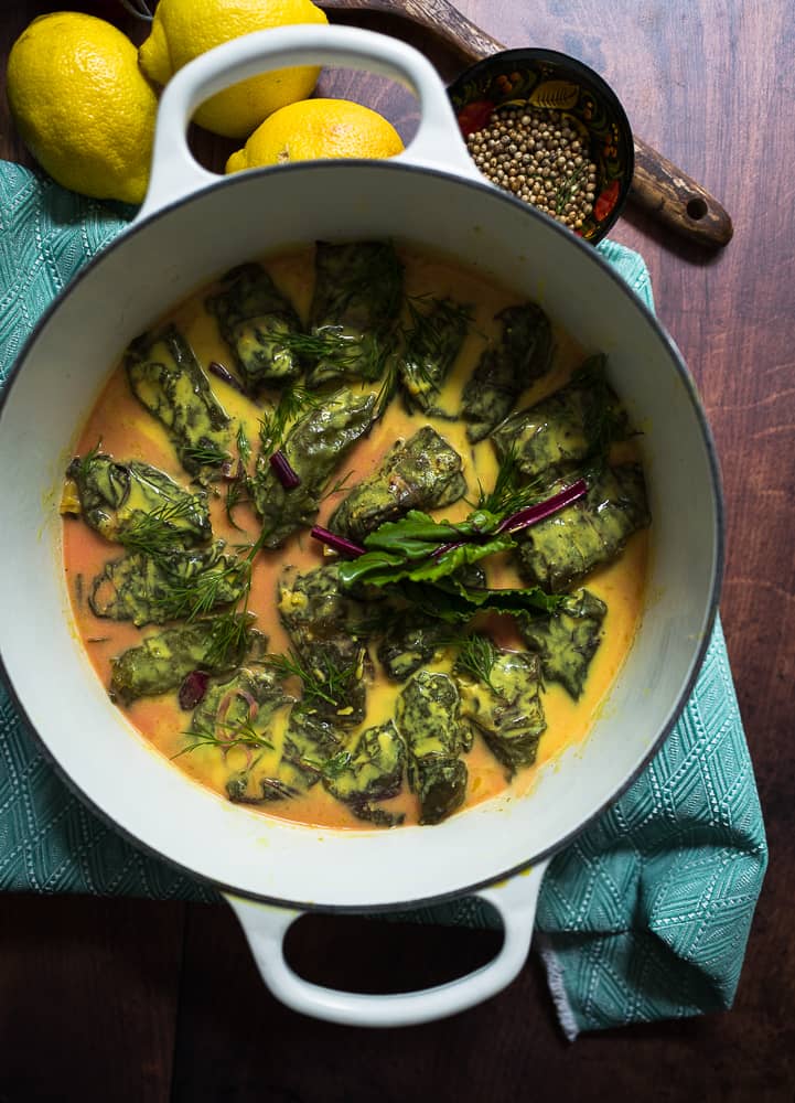 A pot of stuffed beet rolls in lemon sauce