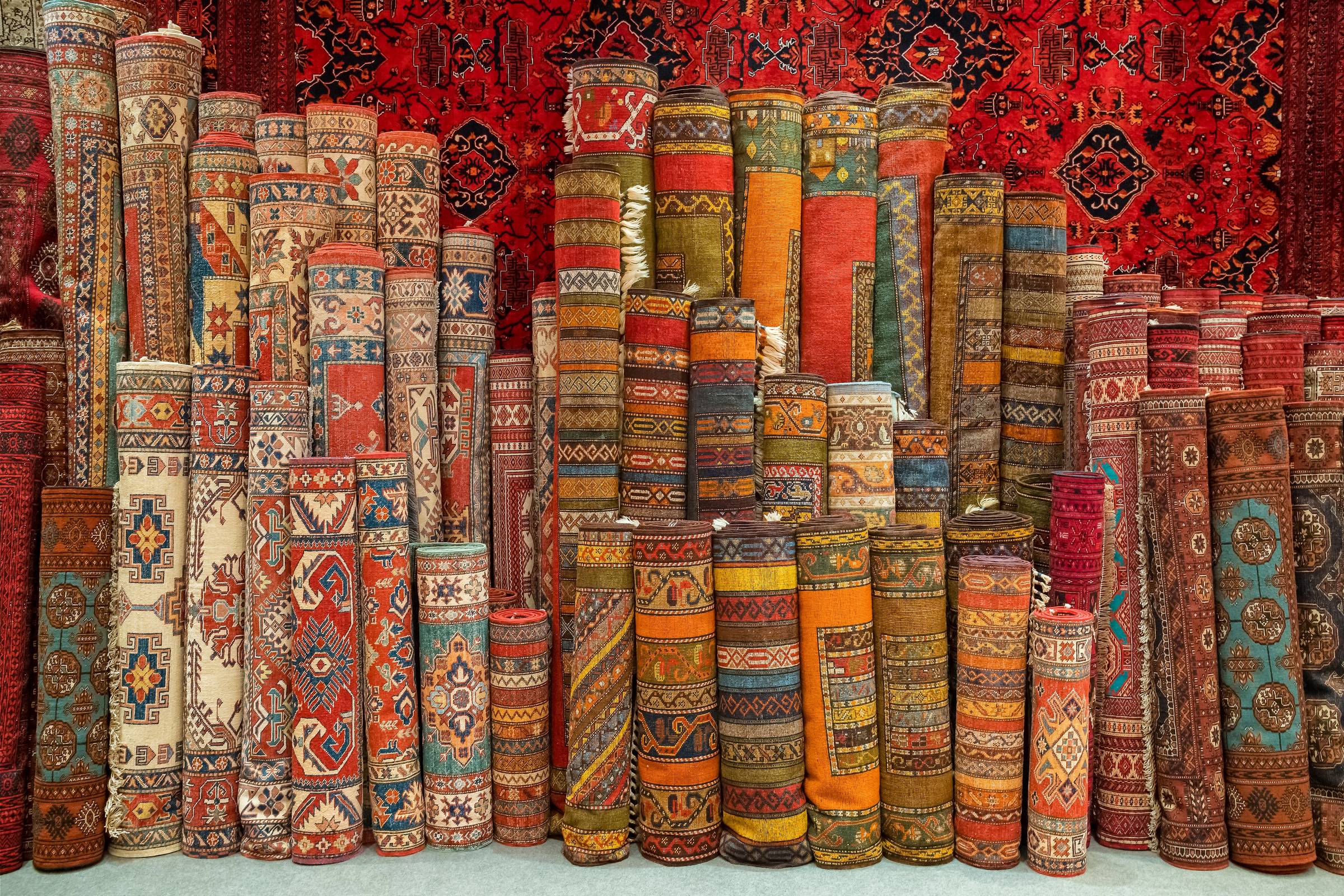 large group of rolled carpets