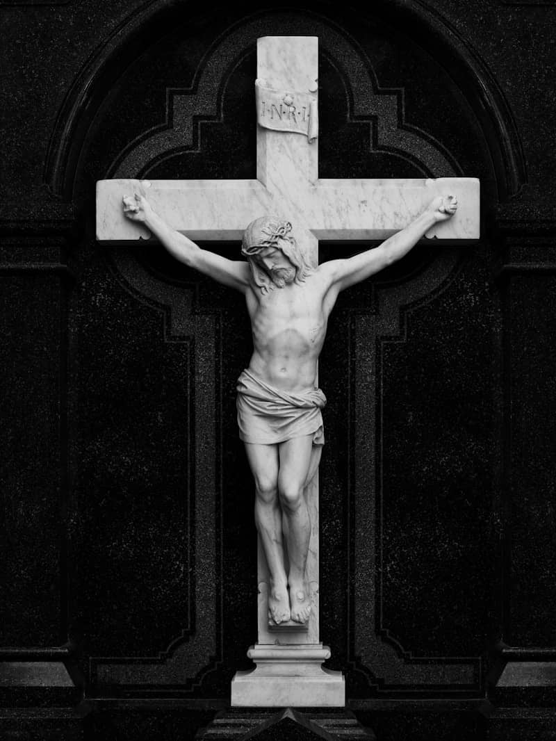 Jesus christ crucified on a marble cross.