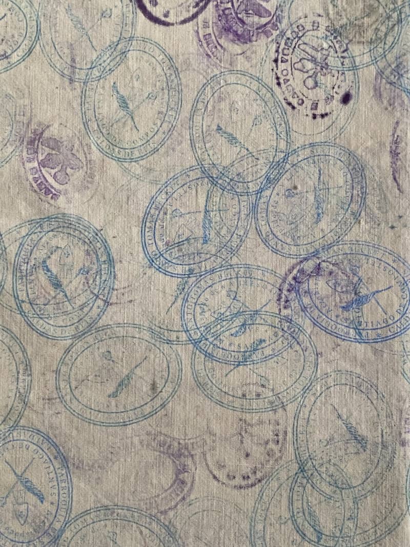 Blue compass stamps scattered on textured background
